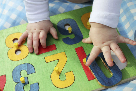 young child doing a number jigsaw