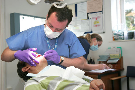 Dentist performing check-up on a patient