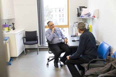 Doctor and patient talking in consultation room