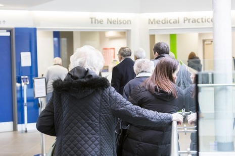 People waiting in a queue at a medical centre