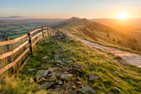 A stone footpath and wooden fence leading along the Great Ridge in the Peak District