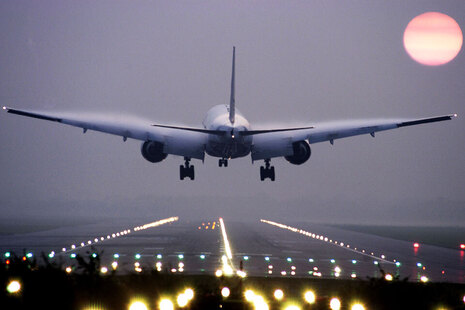 Passenger airplane landing at Gatwick Airport.