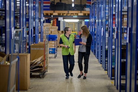 Two colleagues in discussion at a warehouse