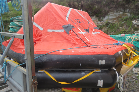 Recovered liferaft secured to a road trailer.