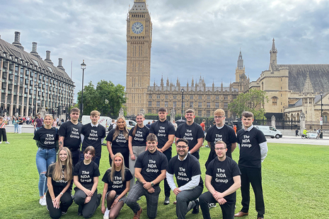 A group of apprentices from across NDA on the grass outside big ben and the houses of parliament
