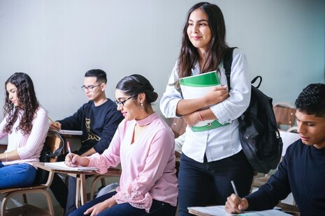 Students writing at desks.