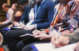 People taking notes at a meeting