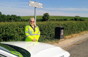 Image showing Highways England Inspector Marcy Belcher next to the new bin and signage at the A46 layby