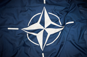 NATO logo on a flag.