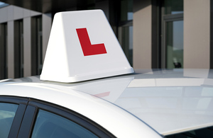 Photo of an L plate rooftop box on a driving school car