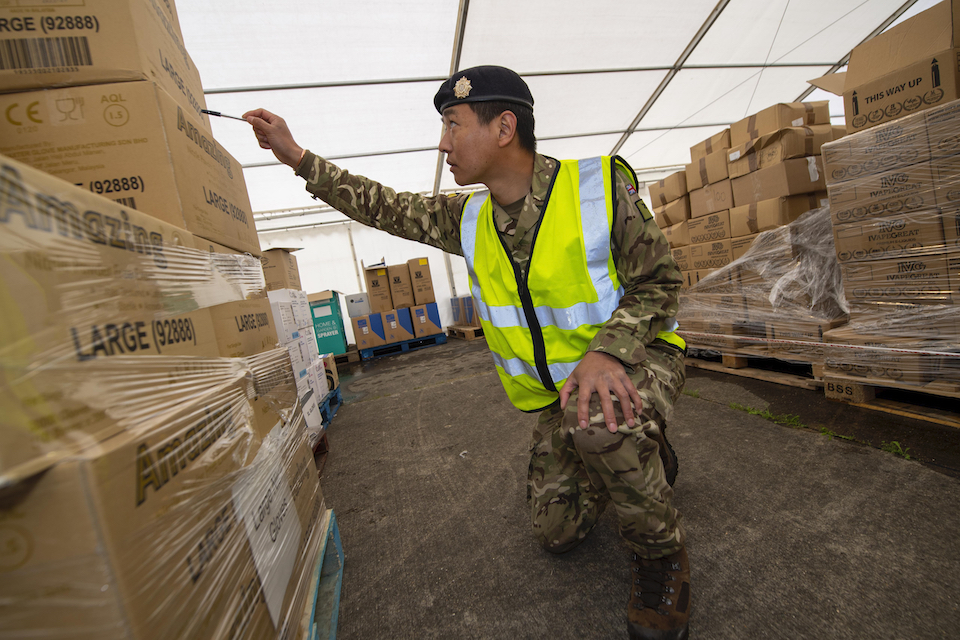 Soldier checking PPE shipment.