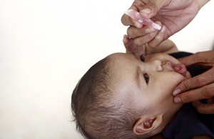 Baby receiving oral vaccine
