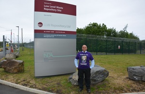 John Maxwell stands next to LLWR totem outside the company site