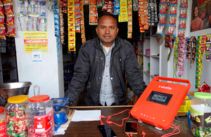 Man at a phone-charging kiosk