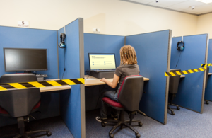 Photo of a woman sitting at a desk taking a theory test.