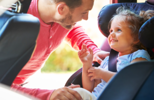 Parent puts child in car ahead of journey