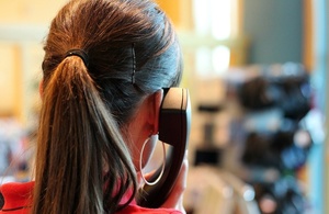 Image showing back of woman's head with telephone against ear