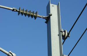 Image of overhead wires on a rail line.