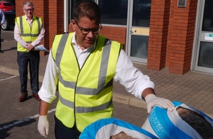 Alok Sharma installs insulation as he visits Instagroup. in Wokingham