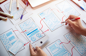 A designer drawing a new design on paper