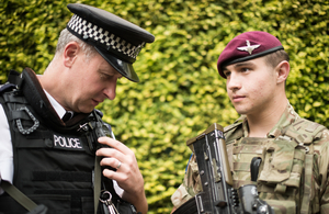 Police officer and paratrooper in full uniform.