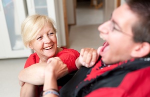 A carer talking to a man in a wheelchair