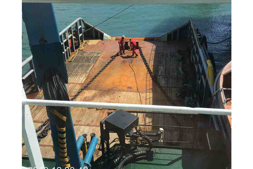 Two men prepare the Tugs for towing.