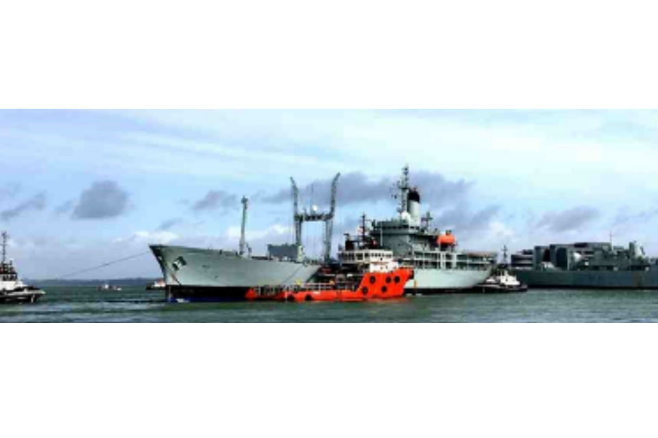 Black Rover with lots of other smaller boats to guide her out of the Naval Base.