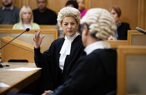 Image of barristers conferring in courtroom