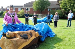 Mayor Councillor Tina Reavey lifts the covers off a bench