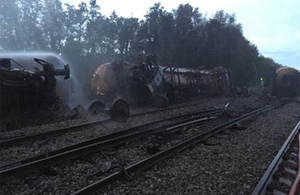 Derailed tank wagons, over turned showing underside of wheel sets and substantial damage to track.