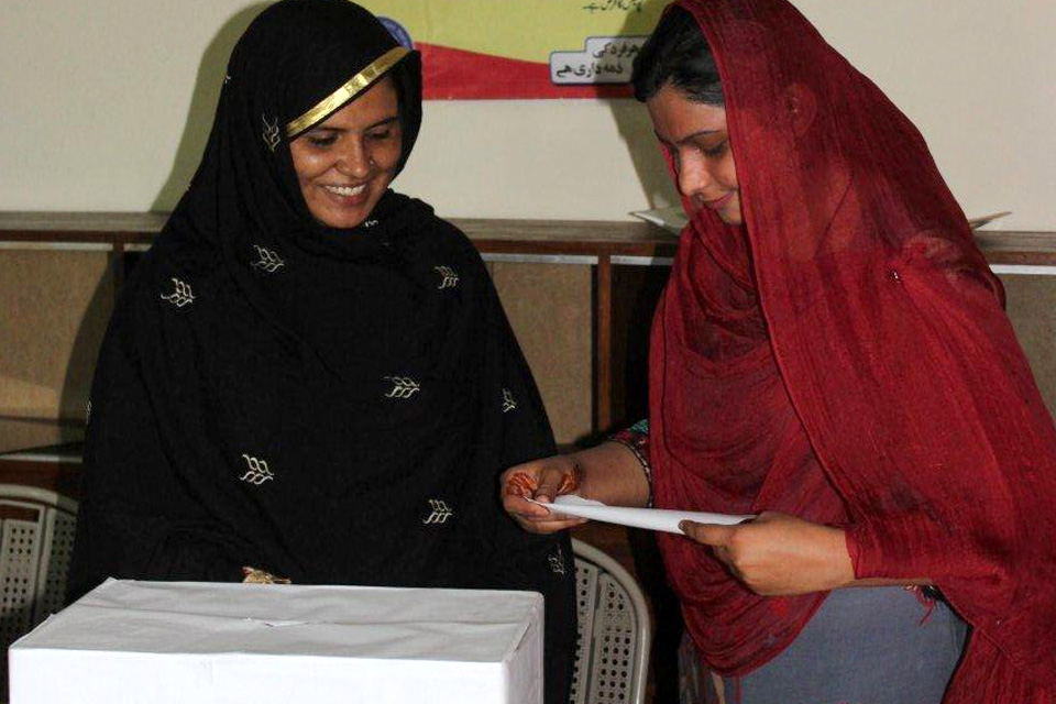 Kausar with Kanwal (in red), an election mobiliser, who encouraged women to register through the voter mobilisation strategy. Picture: DFID Pakistan