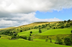 Green fields over hills with a blue sky
