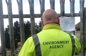 Images shows the Environment Agency placing a notice on the site