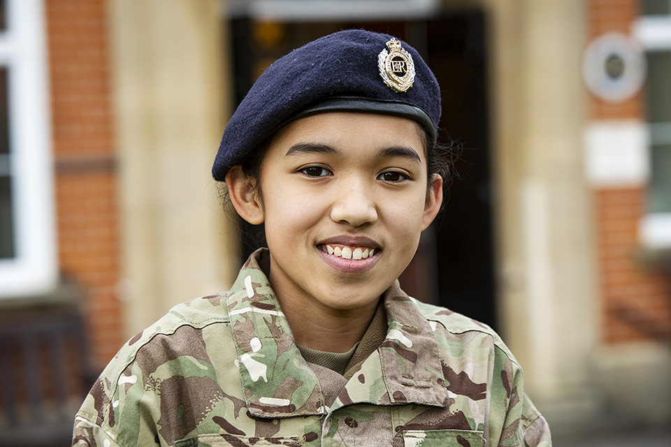 A cadet from the Combined School enjoying her Cadet Experience and smiling straight at the camera in her uniform.