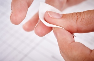 Close-up of fingers being wiped before a finger-prick test