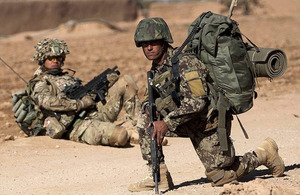 A British soldier (left) looks on as an Afghan warrior pauses during a patrol (stock image) [Picture: Corporal Jamie Peters RLC, Crown copyright]