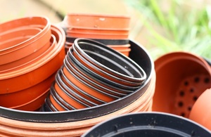 Several terracotta coloured plant pots are stacked into one another.