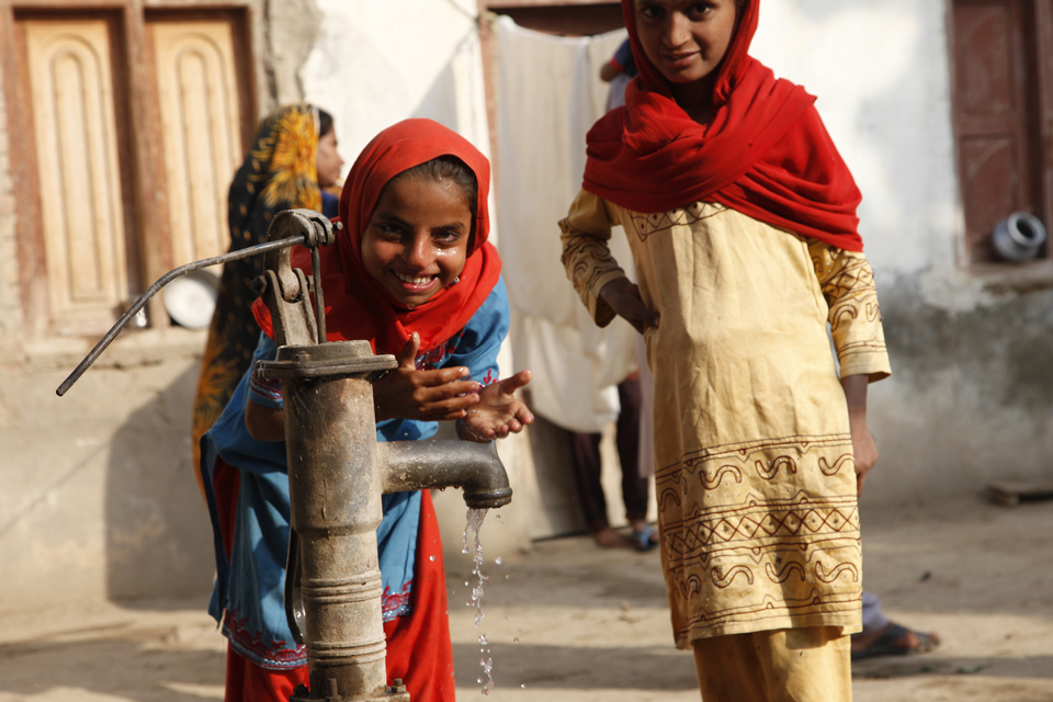 Ten-year-old Shakila drinks clean water from a hand pump in her village. Picture: Russell Watkins/DFID