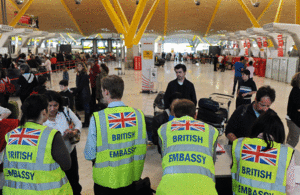 British Embassy staff assisting passengers at Barajas airport.