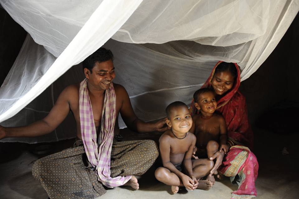 Picture of Milu Jani and his family under a bednet. Picture: DFID