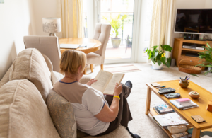 A woman at home reading a book