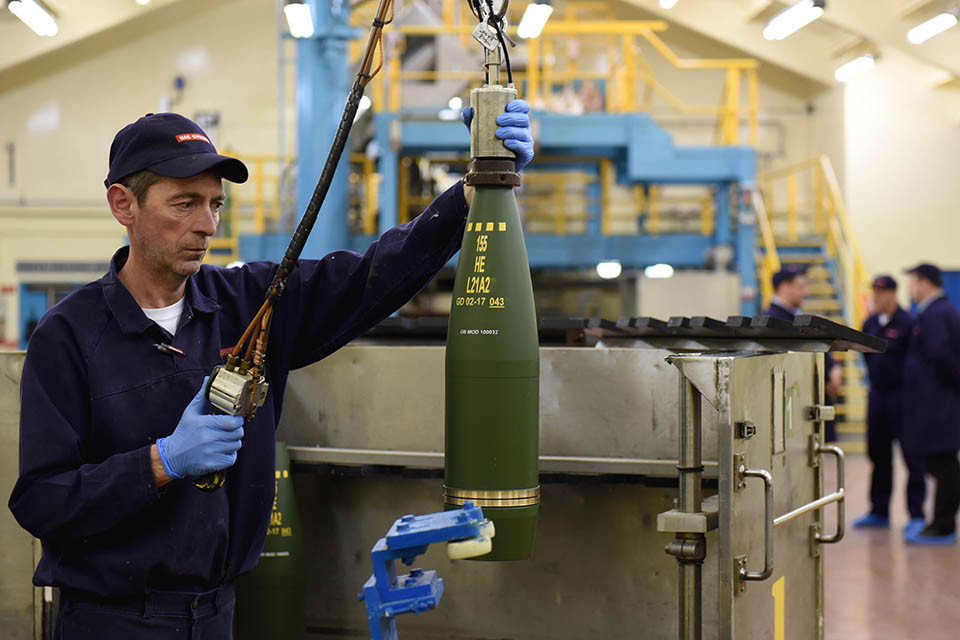 A man works on a shell casing in the BAE Systems factory.