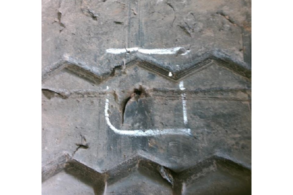 A 25mm cut to tread area and less than 10% of the section width, with no cords damaged or exposed