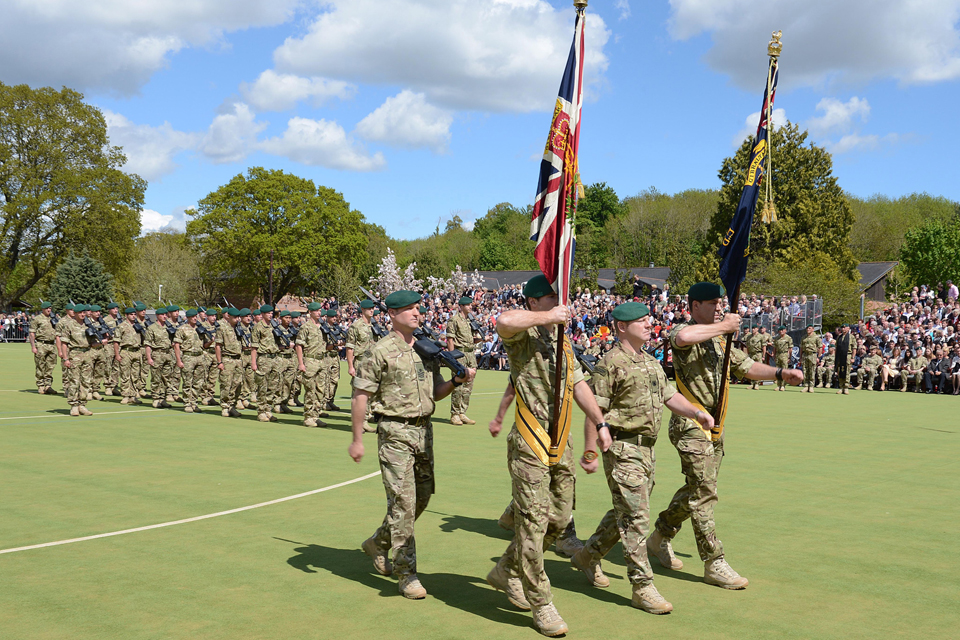Royal Marines of 40 Commando parade with their colours at Norton Manor Camp