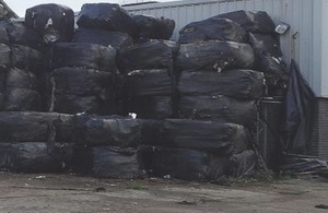 Piles of waste stacked in black plastic bales