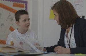 Teacher talking to a pupil in the classroom