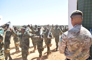 Soldiers and officers from 8 Brigade, SNA, march past a UK instructor during their training graduation ceremony in Baidoa, Somalia.