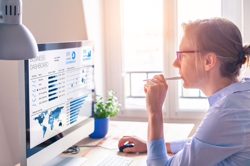 Businesswoman looking at dashboard on screen