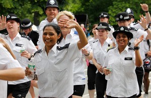 Metropolitan Police officers wave for the camera.